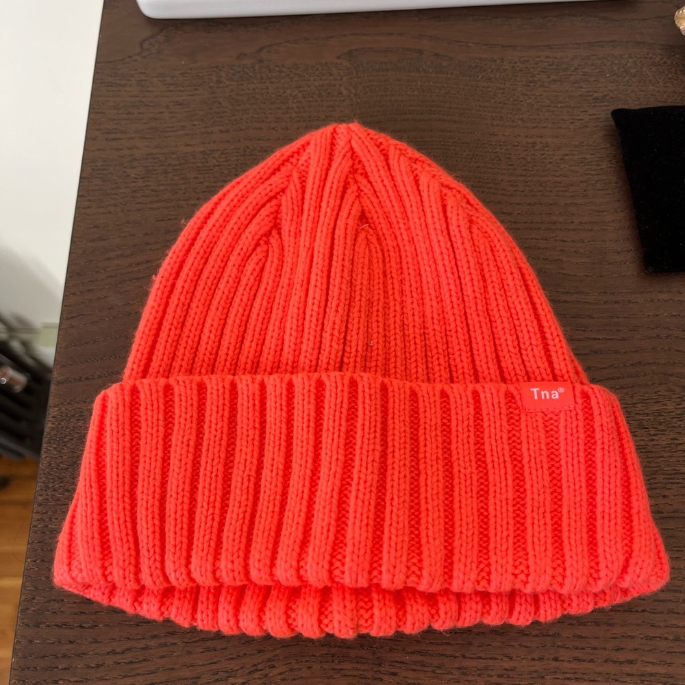 TNA rush beanie-never worn. Pretty orange color